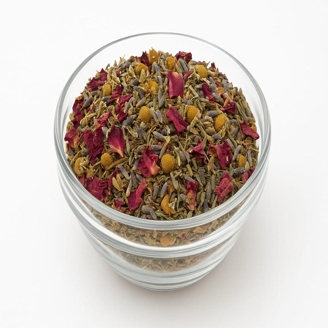 Glass jar filled with a mix of dried herbs and flowers on a white background