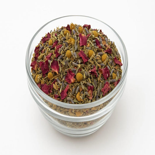 Glass jar filled with a mix of dried herbs and flowers on a white background